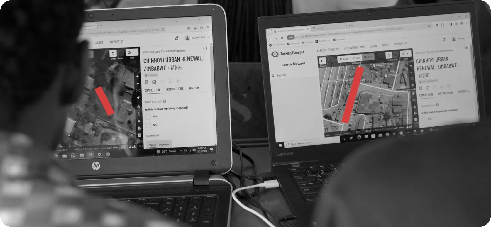 Black and white image of two people doing remote mapping
