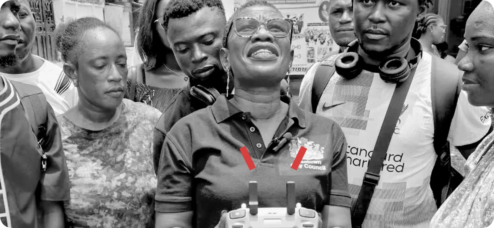 Black and white image of the Mayor of Sierra Leone holding a drone control